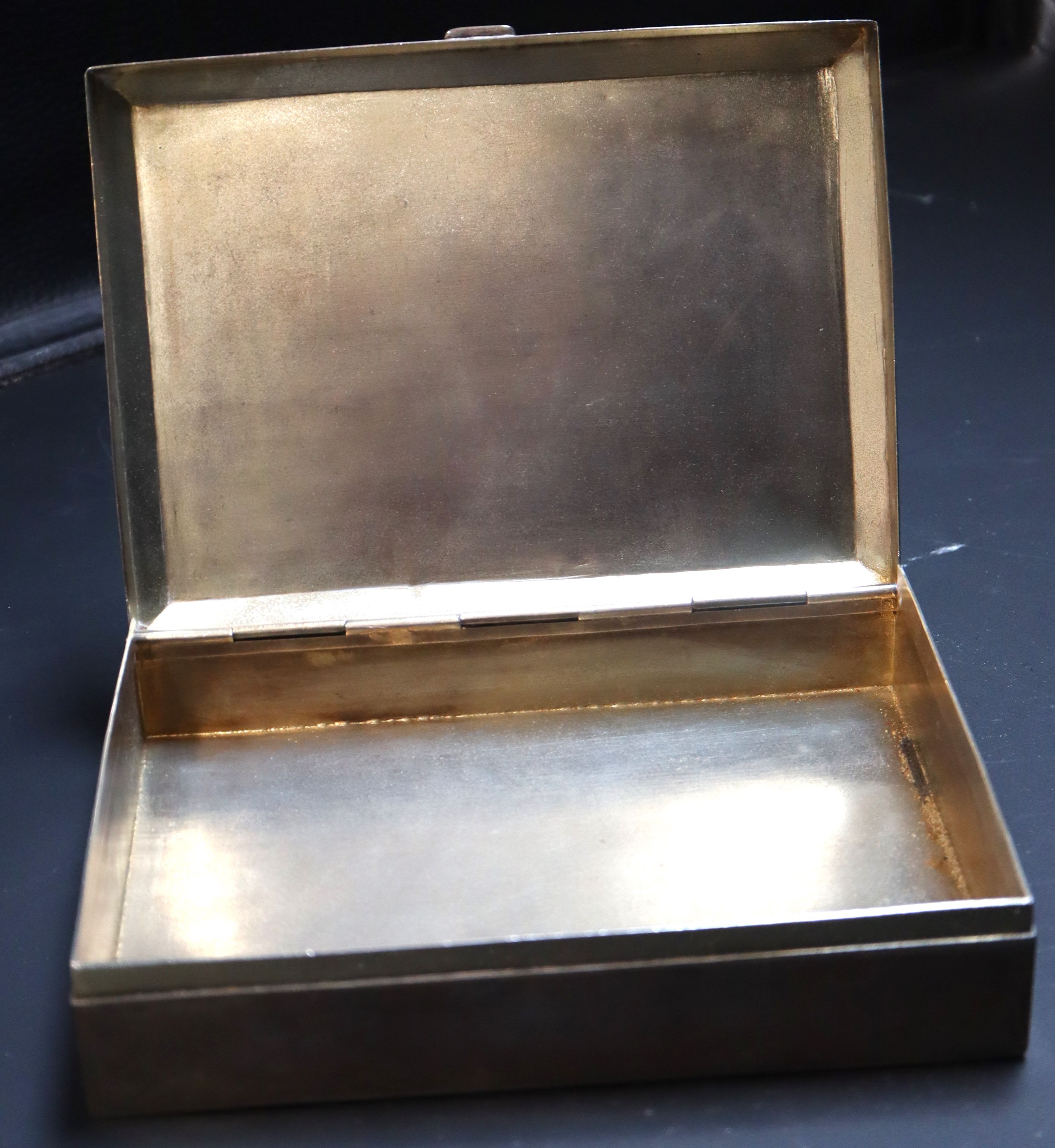 An Indian white metal cigarette box, 19.3cm, 22.5oz.